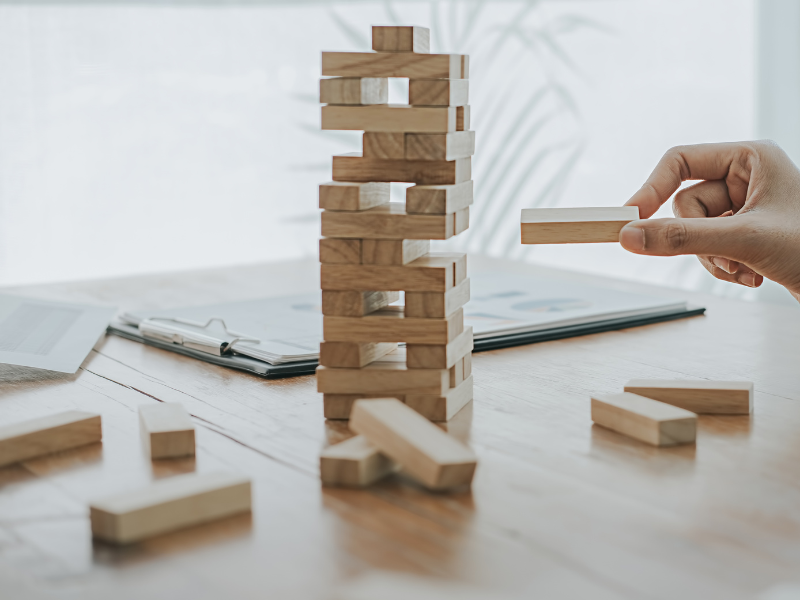 Stacking the wooden toy.